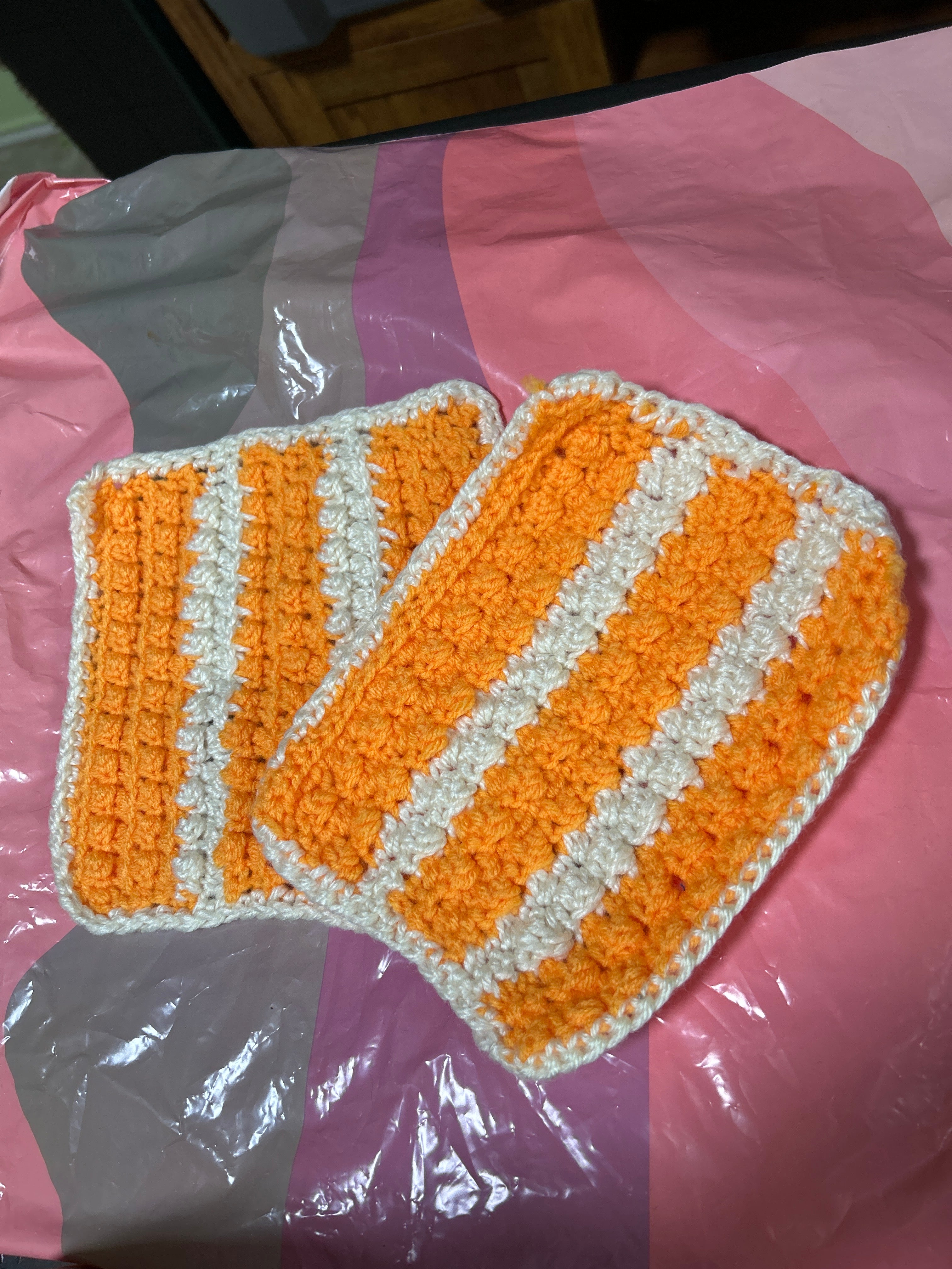 2 handmade crocheted potholders in orange & white