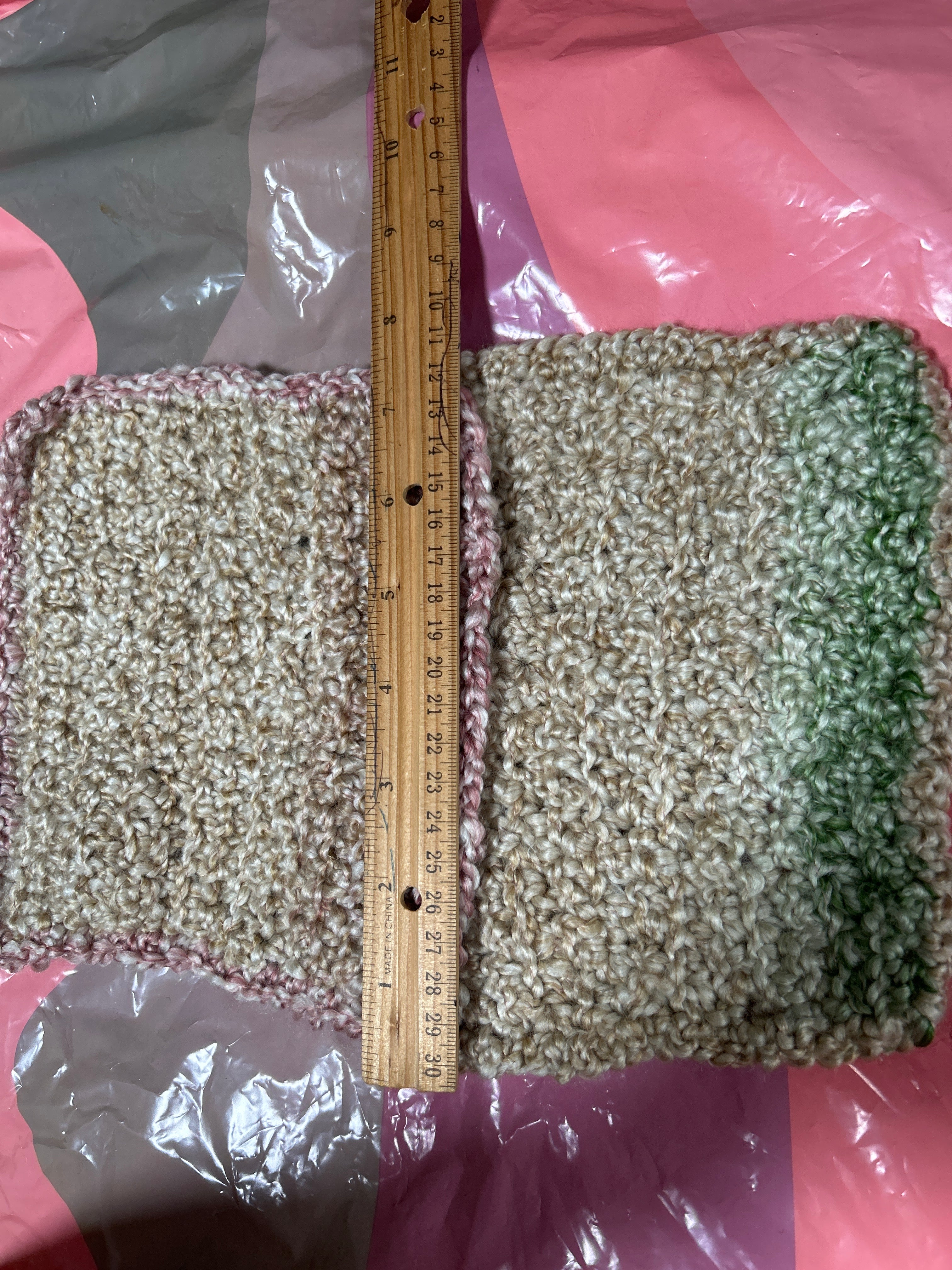 Measuring tape on a textured green and brown surface with pink and purple backgrounds