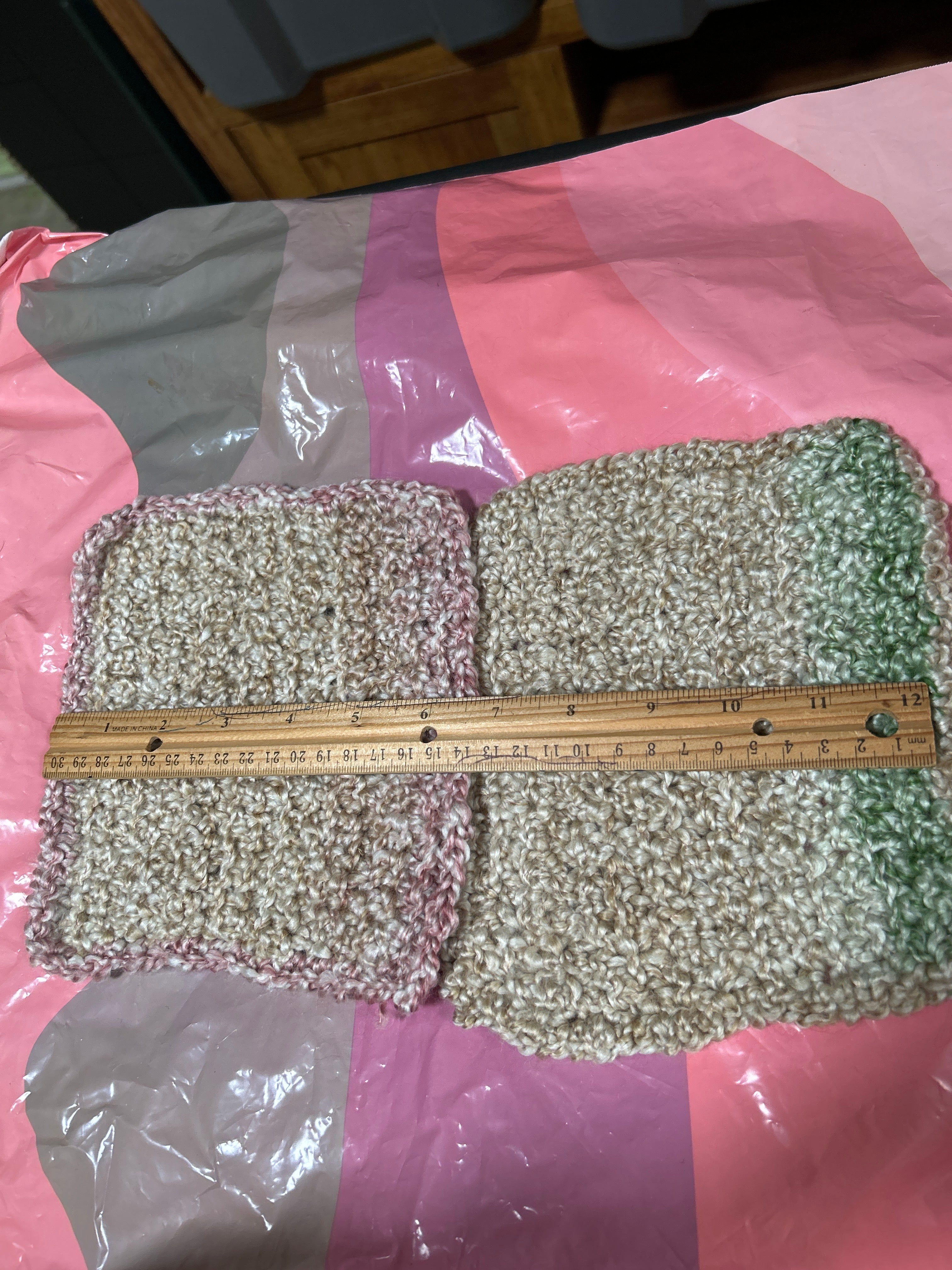 A pair of handcrafted crocheted wide head pot holders or hot mats.