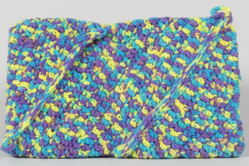 Colorful patterned fabric with a ruler for scale on a pink and gray background