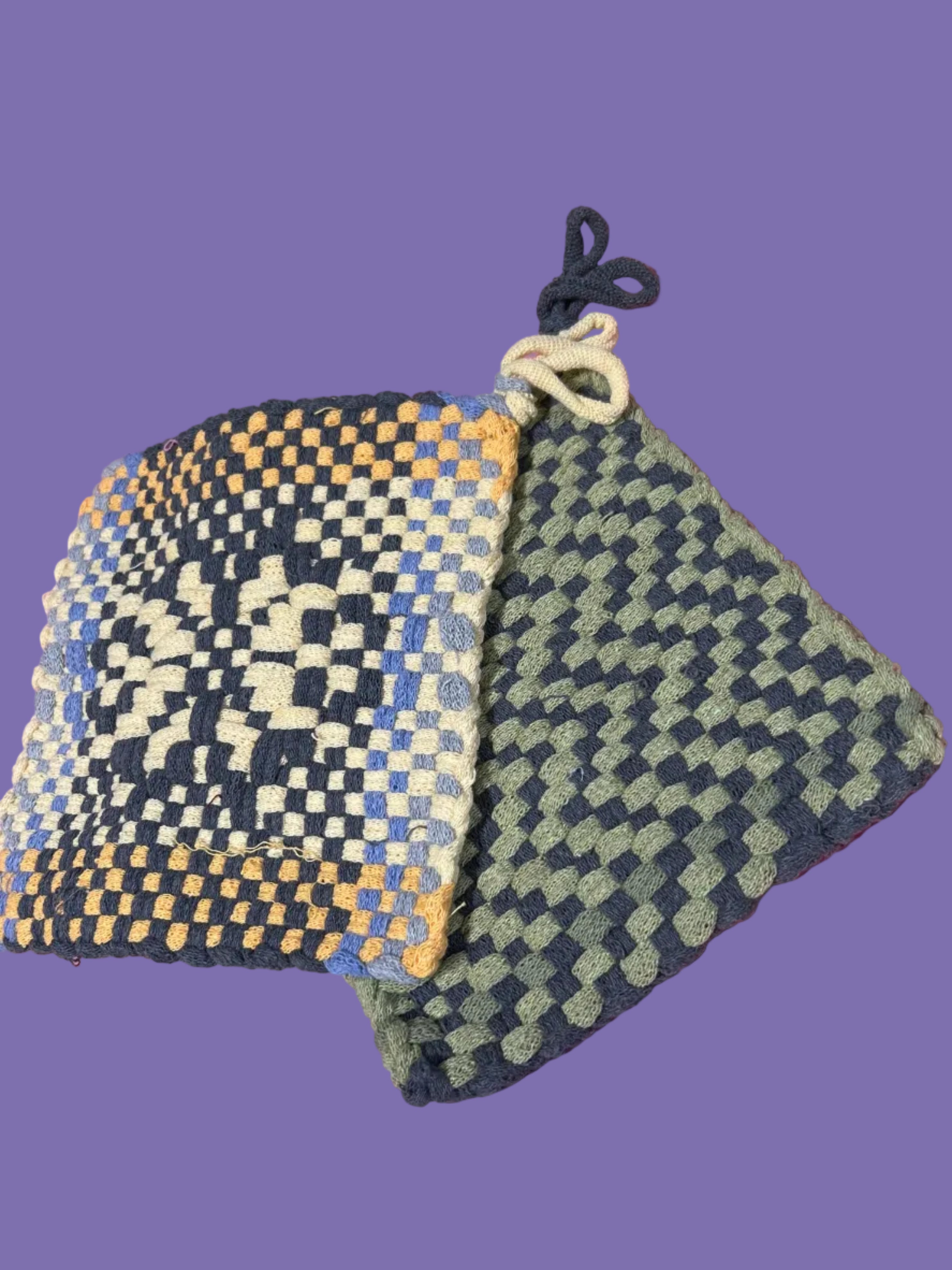 Woven pouches with geometric patterns on a pink surface