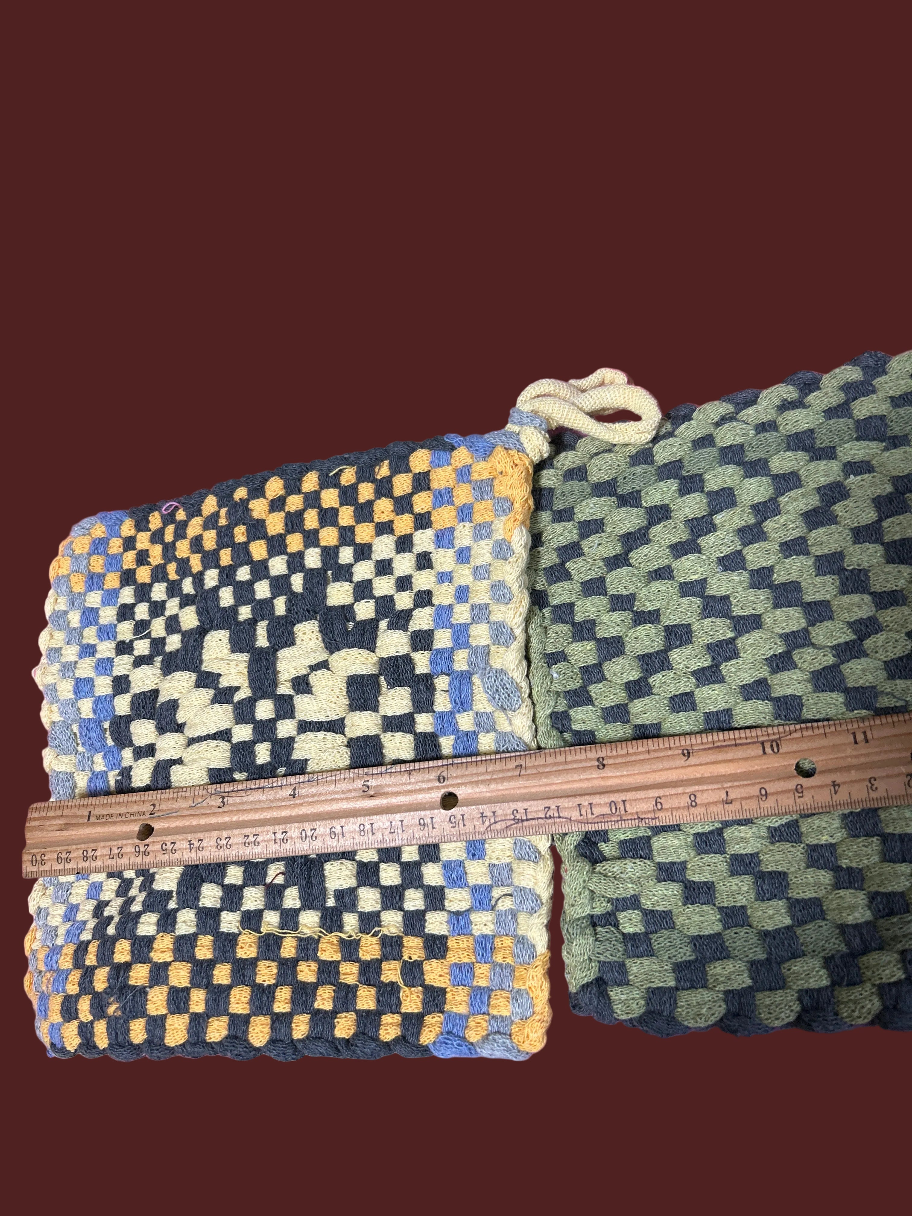 2 handmade woven potholders or hot mats.