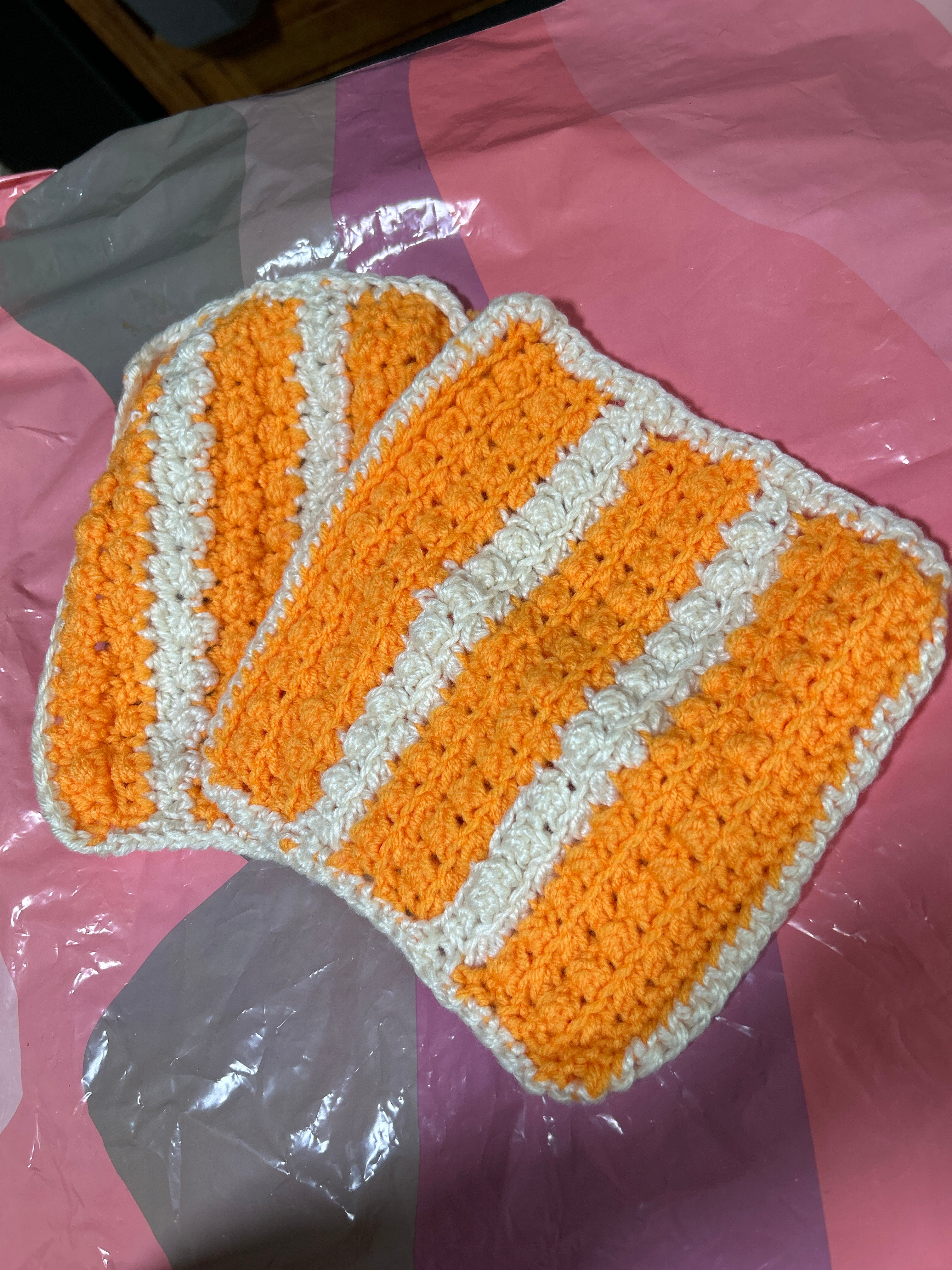 2 handmade crocheted potholders in orange & white